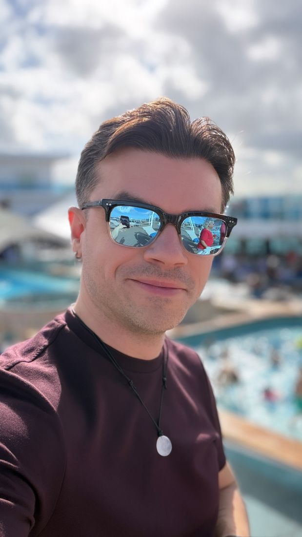 Justin in sunglasses on a sunny cruise ship pool deck